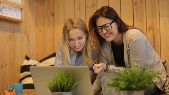 Two Beautiful Girls Smilling And Use Laptop  alt