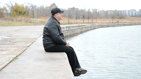 Man Sitting on Concrete Slabs 