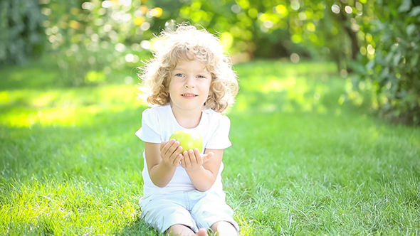 Happy Child Eating Apple