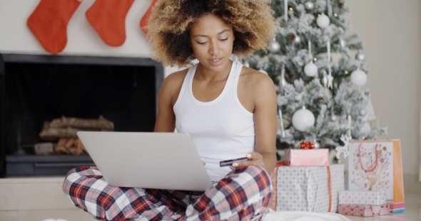 Young Woman Shopping Online For Christmas alt