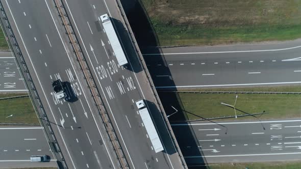 Convoy of Trucks Ride on the Highway Bridge, Road Junction Near Forest, Logistic Transportation alt