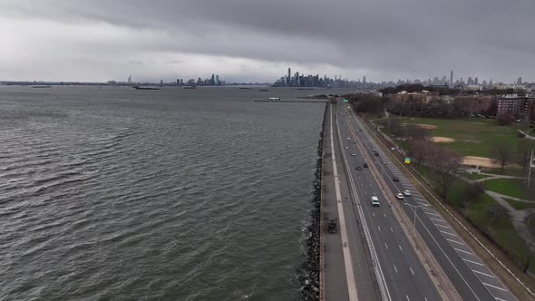An aerial view over the paved walkway along the Belt Parkway by Upper Bay in Brooklyn NY. The drone alt