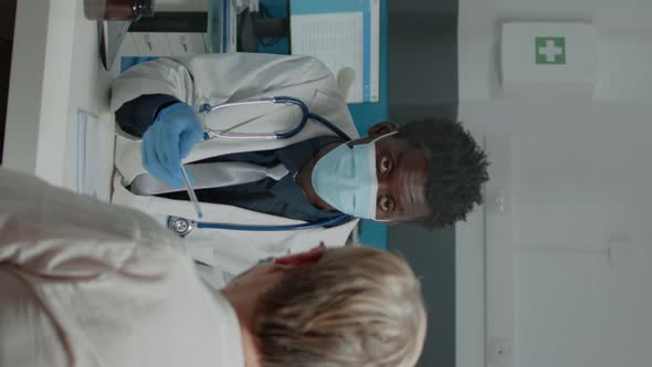 Vertical Video Adult Medic Discussing Medical Treatment alt