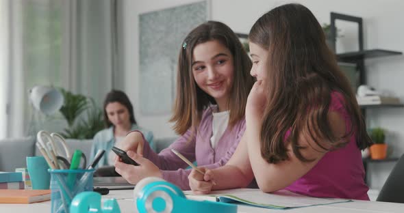 Young girls connecting to social media using their smartphone