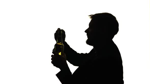 Man in the Room Sits Opens and Drinks alt