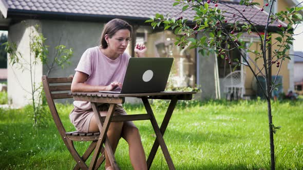 A Woman Working From The Garden With Her Laptop alt