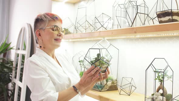 Careful Female Florist Take Care of Plants alt