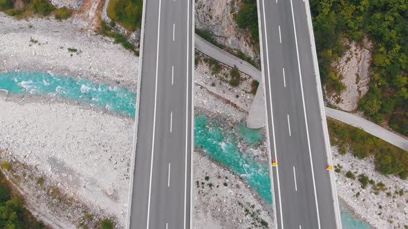 Aerial Top View of Viaduct with Multilane Highway and Tunnel. Traffic on Bridge in Mountains alt