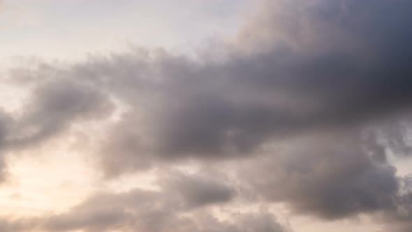 Orange clouds running over the blue sky.