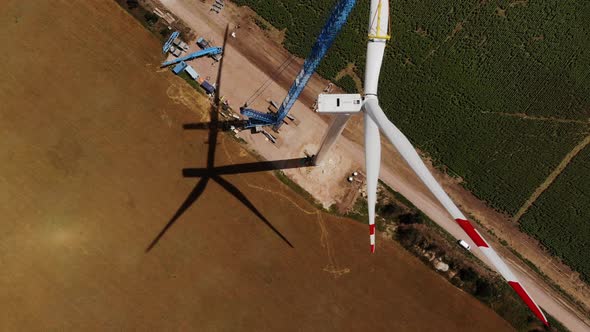 Tower Crane Installs Wind Machine Blade Part Above Fields