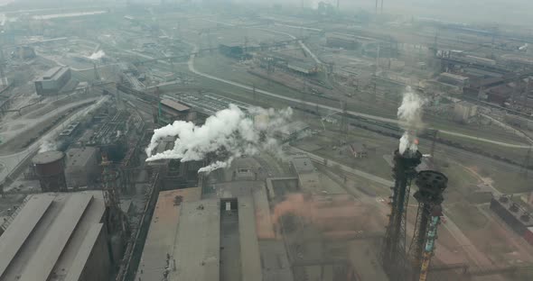 Epic Aerial of High Pipes with Smoke Emission. Plant Pipes Pollute Atmosphere. Industrial Factory alt