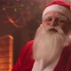 Merry Santa Claus Is Laughing Kindly Sitting at Warm Decorated Room at Xmas Holidays, Looking at - VideoHive Item for Sale