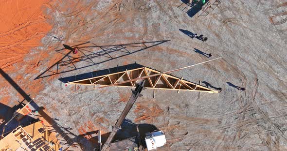 Construction a Crane Holds Timber Frame House of Residential Building with a Without Under alt