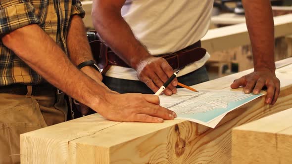 Two Workers Discuss Drawing at Home