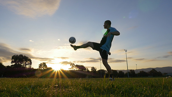 Soccer (Football) Player Juggles Ball At Sunset 2