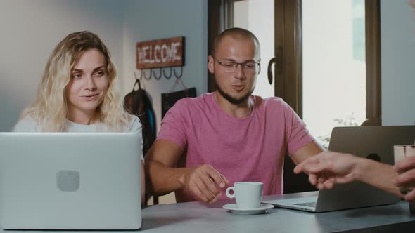 Freelancers couple working together in coffee shop with laptop  browsing online. alt