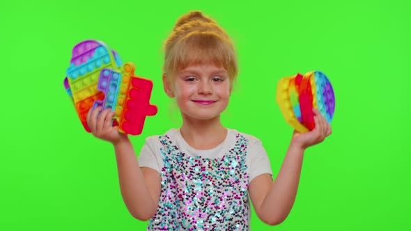 Smiling Child Girl Kid Holding Squeezing Antistress Pop It Touch Screen Toys Simple Dimple Game alt