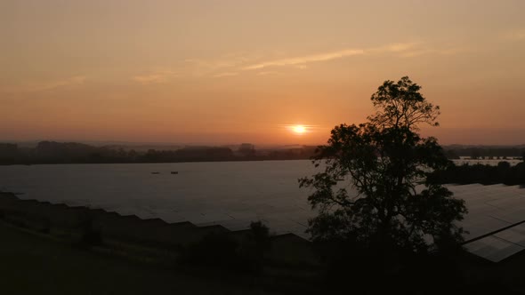 Aerial view over solar farm at sunrise