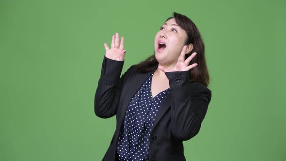 Mature Beautiful Asian Businesswoman Looking Surprised alt