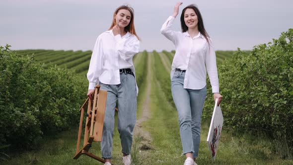 Elegant and Beautiful Girls Painting in a Field alt
