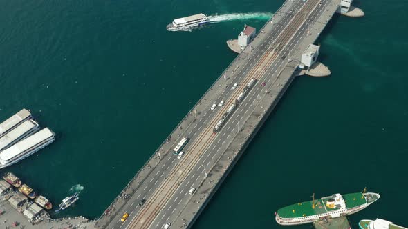 Public Transportation Tram Train Passing Galata Bridge Over Bosphorus in Istanbul with Seagulls and alt