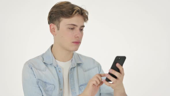 Young Man Celebrating on Smartphone on White Background alt