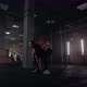 A Strong Woman Makes Efforts and Overcoming Difficulties Lifts a Dumbbell in a Dark Gym - VideoHive Item for Sale