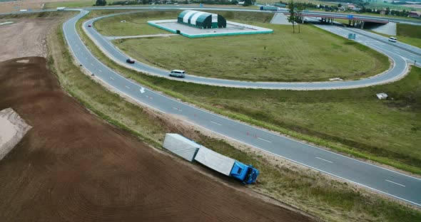 Truck crash drone shooting. Truck lies inverted in a ditch. Truck driver has an accident