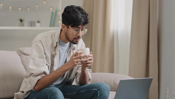 Young Freelancer Male Business Man Bearded Guy in Glasses Drinks Tea Coffee Delicious Drinking at alt