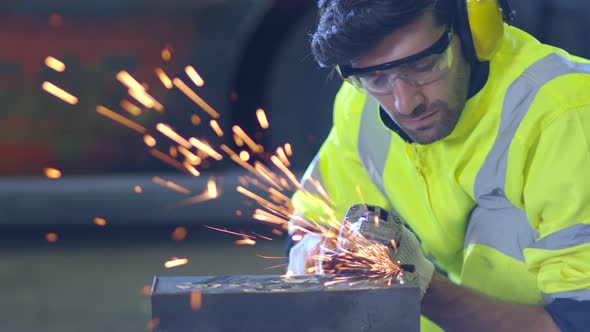 Caucasian male worker in a safty uniform wear welders leathers,Electric wheel grinding alt