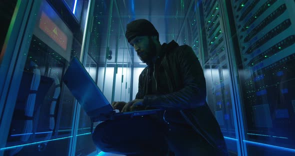 Adult Man Hacking Servers with Computer alt