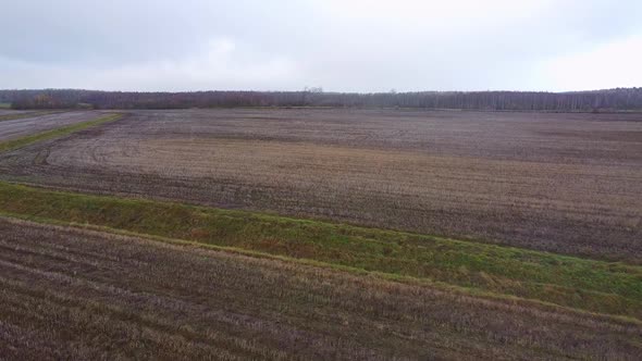 Aerial view over a harvested field in late autumn