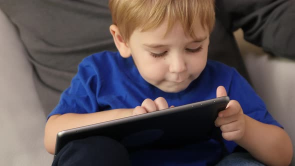 Father and Son using digital tablet together