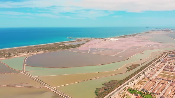 Multicolored Salt Lakes with Coastal Salt Marshes, Aerial View, Video Shooting with Drone alt