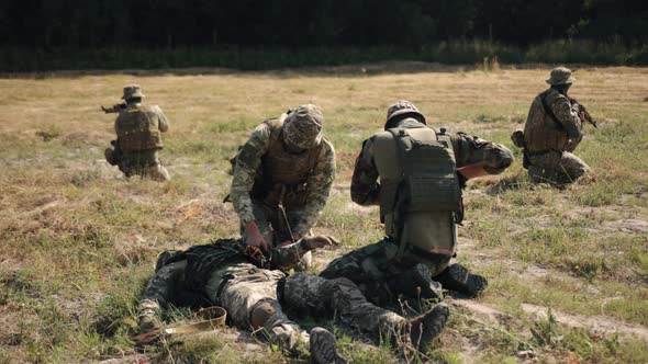 A Military Man Uses a Medical Tourniquet to Stop Bleeding in First Aid and Prevent Bleeding on Hand alt