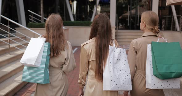 Backside View of Stylish Young Women Walking and Carrying Paper Bags After Shopping, Millennial alt
