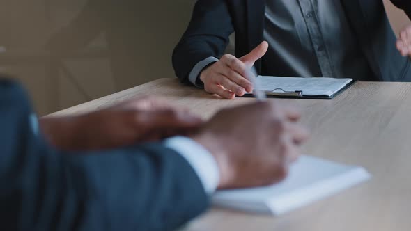 Closeup of Male Hands of Two Colleagues in Office Brainstorming Negotiations alt