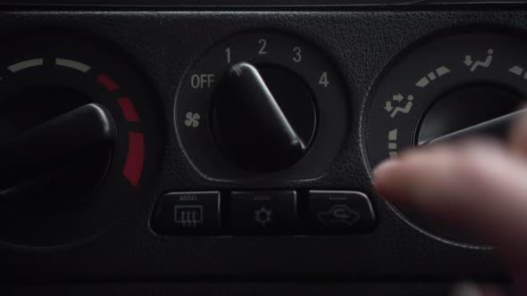The Woman Turns on the Fan and Presses the Button for the Internal Ventilation in the Car alt