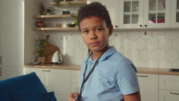 Strict Little African American Football Referee Whistling and Showing Red Card alt