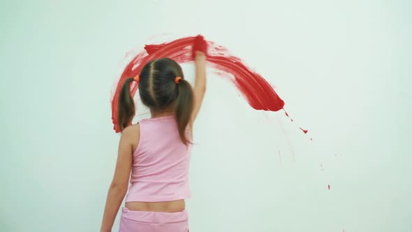 Little Girl Child Preschooler Draws Hands Paints On White Wall alt