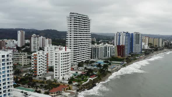 Aerial view, flying over a city along the beaches of the Pacific ocean  alt