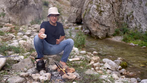 Cleaning Skewers on a Campfire for Cooking alt