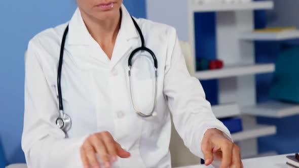 Physiotherapist examining x-ray alt