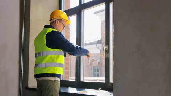 Male Builder with Ruler Measuring Window