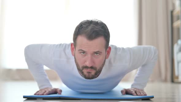 Athletic Man Doing Pushups on Yoga Mat at Home alt