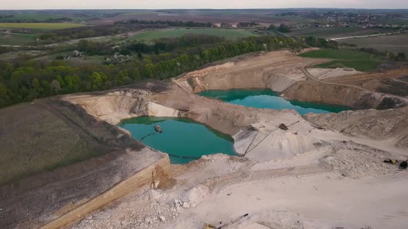 Aerial view of a sand quarry full with green water