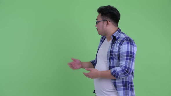 Stressed Young Overweight Asian Hipster Man Showing To Back alt