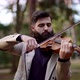 a Classical Musician Plays the Violin in a City Park - VideoHive Item for Sale