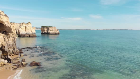 Algarve stunning Limestone Cliffs scattered through Lagos Coastline, Portugal - Aerial Fly-over shot alt