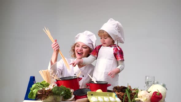 Mother and Daughter Cooking Together in Kitchen, Happy Family. Child Chef alt